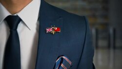 Businessman Walking Towards Camera With Friend Country Flags Pin United Kingdom - Tonga Stock Footage