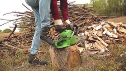 Lumberjack fixing / maintain the chainsaw outdoors. Stock Footage