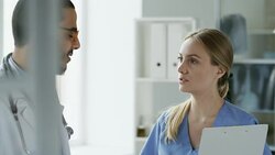 Multiethnic Doctors Discussing Research in Clinic Stock Footage