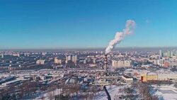 Bad ecology. The thermal power plant located in the center of the residential district, throws out smoke from the high pipe, polluting the atmosphere of the city. Aerial drone video. Stock Footage