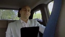 Smiling passenger speaks on tablet in electric car Stock Footage