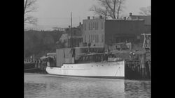 Seaside town with harbor, warehouses, docks and boathouses, etc. News Clip