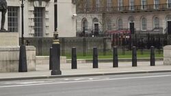 Shots of religious man walking with a warning and an empty Downing street News Clip