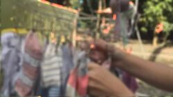 Socks hang drying on the round clothespin drying rack Stock Footage