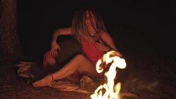 Beautiful young hippie woman with dreadlocks playing on djembe. Funky woman drumming in nature on an ethnic drum with a human skull at night. Slow motion Stock Footage