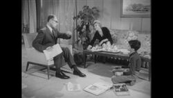 1960s: The family gathers their things in the living room to leave Stock Footage