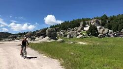 Tourist drives a bicycle trough Tarahumara reservation Stock Footage