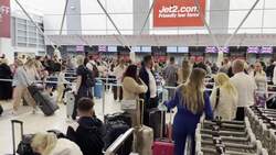 Holidaymakers queue for check-in at East Midlands Airport News Clip