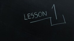 Teacher writing Lesson one Stock Footage