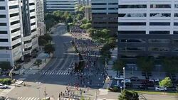 RUNNING RACE - DRONE SHOT - MOVING DOWN COURSE WITH RUNNERS Stock Footage