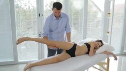 Male physiotherapist giving leg massage to female patient Stock Footage