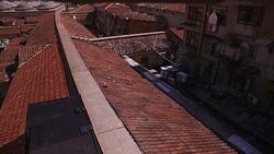 HIGH ANGLE DOWN OF SPANISH TILE ROOFTOPS IN LOWER CLASS RESIDENTIAL AREA. EUROPEAN CITY. Stock Footage