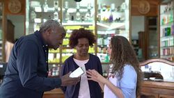 Chemist explaining medication to senior couple Stock Footage