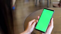 Young woman uses smartphone with green screen Stock Footage