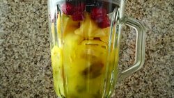 Cocktail from pears, apples, grapes, raspberries, bananas and orange juice.	Slow motion. Stock Footage