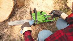 Lumberjack fixing / maintain the chainsaw outdoors. Stock Footage
