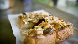 Eating Toast with caramel and almond. Stock Footage