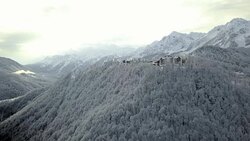 house apartments in the mountain village in the snowy winter forest. Stock Footage