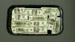 CLOSE ANGLE OF US ONE HUNDRED DOLLAR BILLS WITH BEN FRANKLIN'S IMAGE VISIBLE. 100 DOLLAR BILLS SEEM TAPED OR STUCK ONTO WINDOW OF DOOR. AMERICAN CURRENCY. Stock Footage