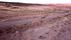 Aerial Drone Footage of Semi-Trucks Rolling Down the Highway Stock Footage