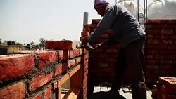 Bricklayer installing bricks on construction site Stock Footage