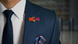 Businessman Walking Towards Camera With Friend Country Flags Pin China - Samoa Stock Footage