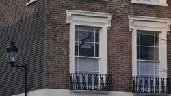 Social housing block of flats next to expensive house in Islington News Clip