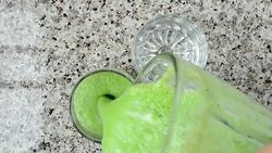 Cocktail from a cucumber, mentha and a lime.	Cocktail is poured in glasses. Stock Footage