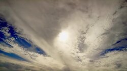 An Ocean of Clear Clouds on A Deep Blue Sky Covers the Sun Timelapse Stock Footage