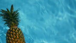 Pineapple Floating In blue Water In Swimming Pool. Healthy Raw Organic Food. Juicy Fruit. Vegetarian, Vegan Nutrition, Vitamins, Diet, summer holidays, vacation concepts. Exotic tropical background Stock Footage