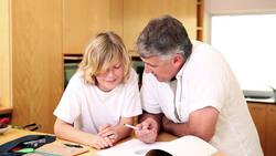 Father using a protractor with his son Stock Footage