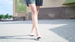 Sexy woman legs in high heels shoes walking in the city urban street. Steadicam Stabilized shot, Female legs in high-heeled shoes, close up Stock Footage