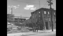 War destruction in Seoul with shells of buildings and debris, shacks, jeeps on street and people walking News Clip