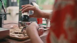 Young woman presses ground coffee using hand. Stock Footage