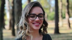 Feminist Girl wearing glasses looking directly to camera smiling Stock Footage