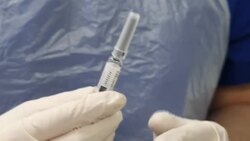 GP holding syringe containing flu vaccine News Clip