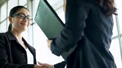 Handshake of businessman demonstrating their agreement to sign agreement or contract between their firms / companies / enterprises. Stock Footage