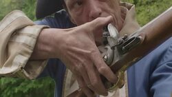 Revolutionary War soldier cocking and aiming musket Stock Footage