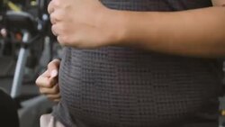 CU TU overweight Asian man running on treadmill Stock Footage