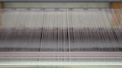Colorful Threads on a loom in weaving loom machine in textile factory Stock Footage