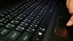 Close-up of a man's hand typing letters on a laptop computer's keyboard with soft focus scene. Stock Footage