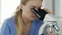 Female Biochemist Using Microscope at Work Stock Footage