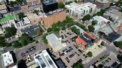 Looking straight down at Denver Street panning up to downtown Skyline of the Mile High City with Rocky Mountain Background Stock Footage