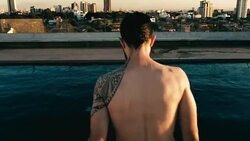 young man jumping to the rooftop pool above the city Stock Footage