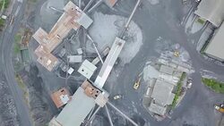 Aerial view Mine and heavy equipment limestone crusher and truck and backhoe Stock Footage