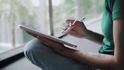 Designer drawing a sketch on tablet using stylus at city Stock Footage