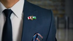 Businessman Walking Towards Camera With Friend Country Flags Pin Japan - Djibouti Stock Footage