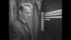 1960s: Man loosens tie and struggles to make a decision inside a voting booth Stock Footage
