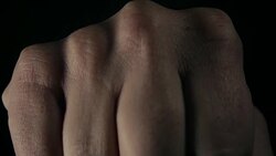 Hand in a fist shape punching close to the camera lens Stock Footage