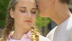 Boy kisses girl, concept of skincare in adolescence, no acne, self-confidence Stock Footage